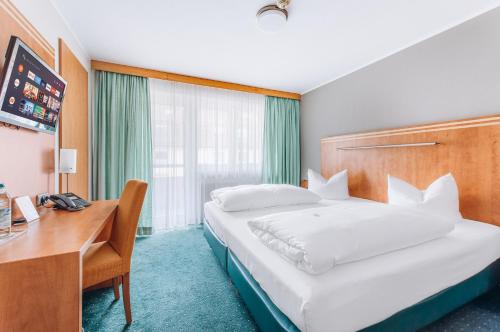 Postel nebo postele na pokoji v ubytování Hotel Isartor