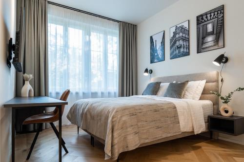 a bedroom with a bed and a desk and a window at N48 Boutique Hotel in Tallinn