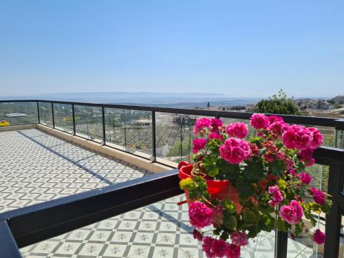 a bouquet of pink flowers on a balcony at סוויטה בכפר ירכא in Yarka