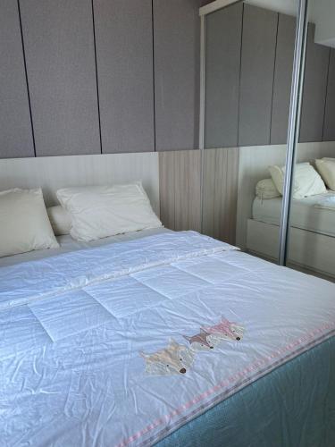a bed with a blue comforter with butterflies on it at Apartment Anderson Benson Orchard Tanglin Tower di atas Pakuwon Mall Surabaya Barat in Lontar
