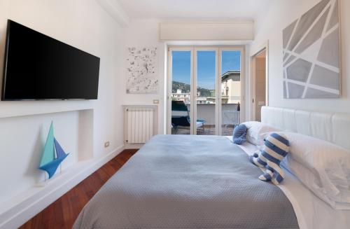 a bedroom with a bed and a flat screen tv at Ag Sorrento Rooms in Sorrento