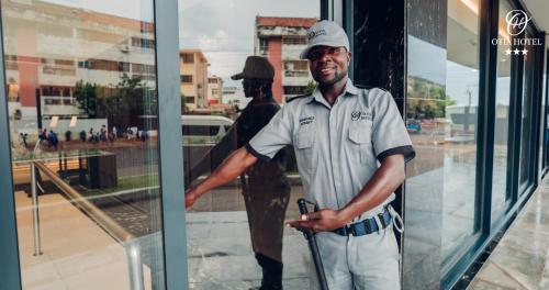 a man is standing in front of a window at OTIA HOTEL in Maputo