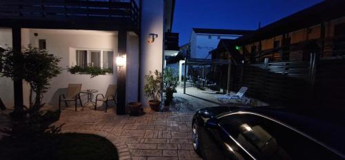 a car parked in front of a house at night at Casa Sebastian in Costinesti