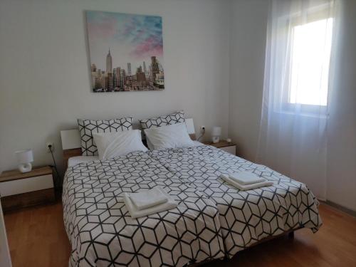 a bedroom with a large bed with two white pillows at Apartment Bella in Pula