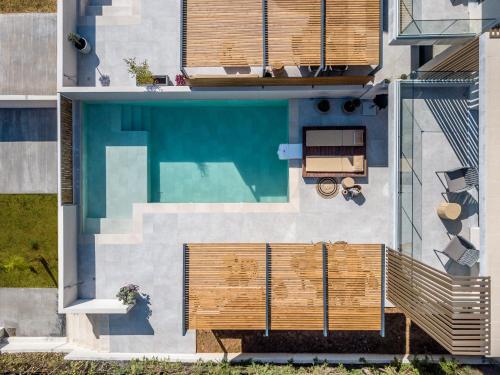 an overhead view of a swimming pool with wooden fencing at Ambient Living in Preveza