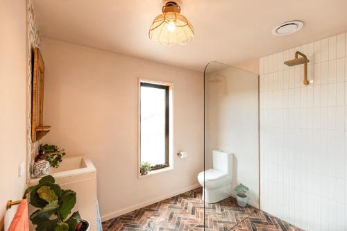 a bathroom with a toilet and a window at Luxury yurt glamping at Littlegrove in Adventure Bay