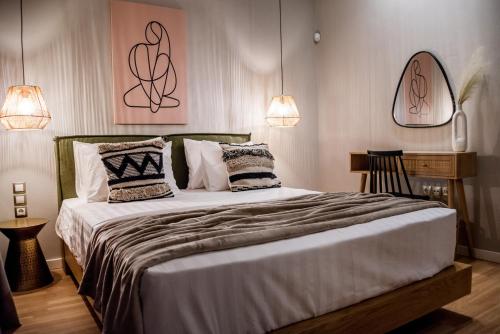 a bedroom with a large bed with two pillows at Ambient Living in Preveza