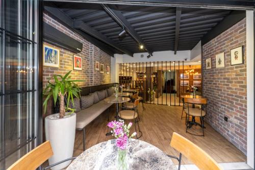 a restaurant with tables and chairs and a brick wall at The Marions Suite istanbul Special Category Taksim in Istanbul