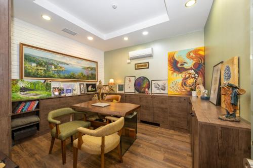 a dining room with a table and some paintings at The Marions Suite istanbul Special Category Taksim in Istanbul