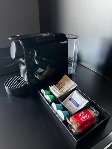 a black container sitting on top of a table at Park Heights by the Warren Collection in Msida