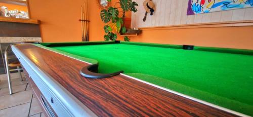 a pool table in a room with a green cloth at camping mas du sartre in Auriolles