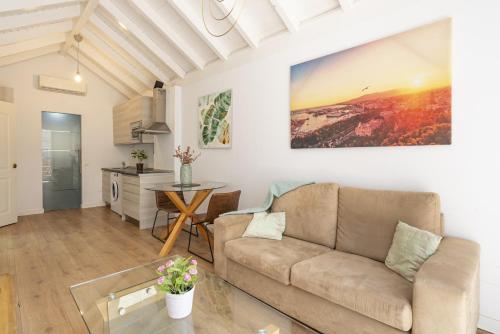 a living room with a couch and a table at Urbe10 Terrace Constitucion 1 Bedroom Apartment in Málaga