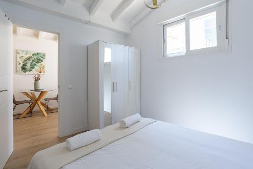 a white bedroom with a large bed and a window at Urbe10 Terrace Constitucion 1 Bedroom Apartment in Málaga