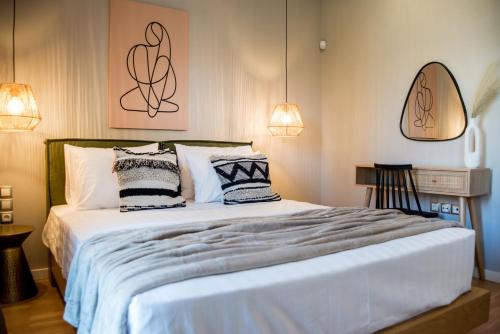 a bedroom with a large bed with two pillows at Ambient Living in Preveza