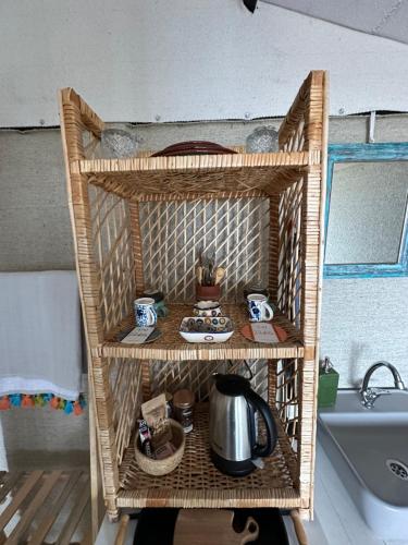 a wicker shelf with a tea kettle on it at Mandra - Nature Living in Bodrum City