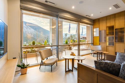 a living room with a view of the mountains at Denthis Hotel - Taygetos Mountain Getaway in Artemisía
