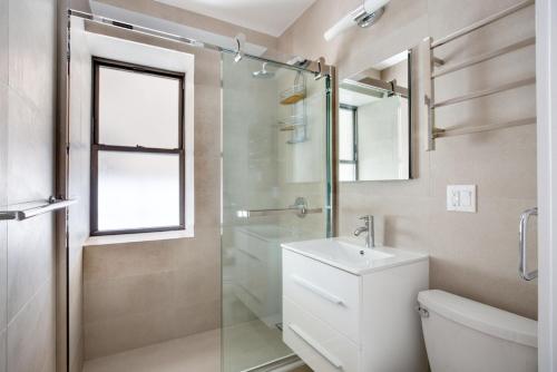 a bathroom with a shower and a toilet and a sink at SoHo 1br w outdoor space in-unit wd NYC-1142 in New York