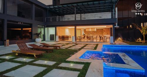 a house with a swimming pool and a patio at OTIA HOTEL in Maputo