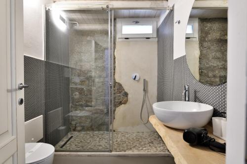 a bathroom with a shower and a white sink at Loft Favoloso con piscina in Tortolì