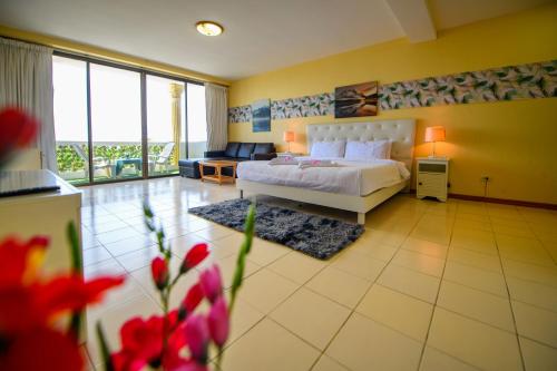 a bedroom with a bed and a living room at Happy Vikings - Beachfront in Jomtien Beach