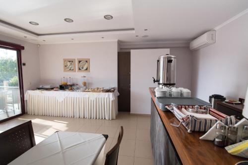 a kitchen with a counter with a table in it at Christina Studios in Lygia
