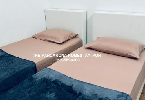 Ένα ή περισσότερα κρεβάτια σε δωμάτιο στο The Pancarona Homestay forMuslims, Ipoh, Perak