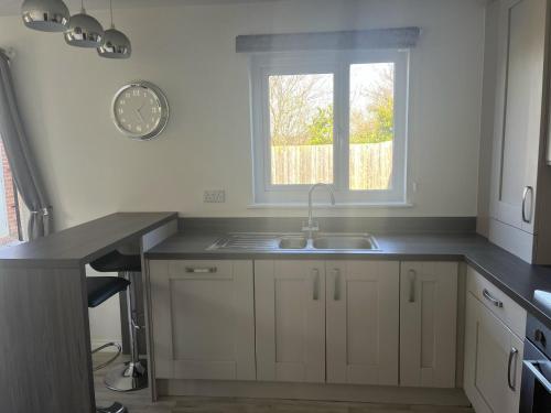 a kitchen with a sink and a window at Remarkable 3-Bed House in Wirral in Wirral