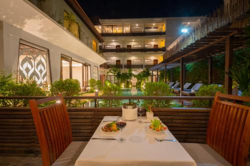a table with two plates of food on a balcony at Siemreap Vasinh Residence in Siem Reap