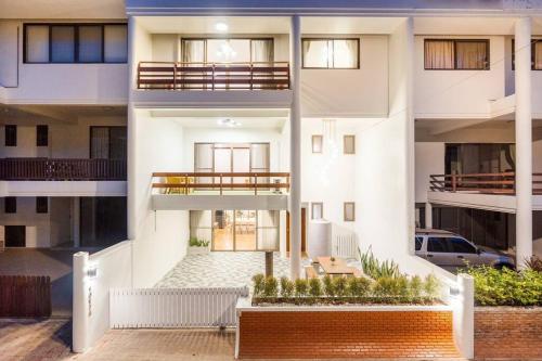 an apartment building with a balcony and a patio at City white beach house2 Hua Hin in Hua Hin