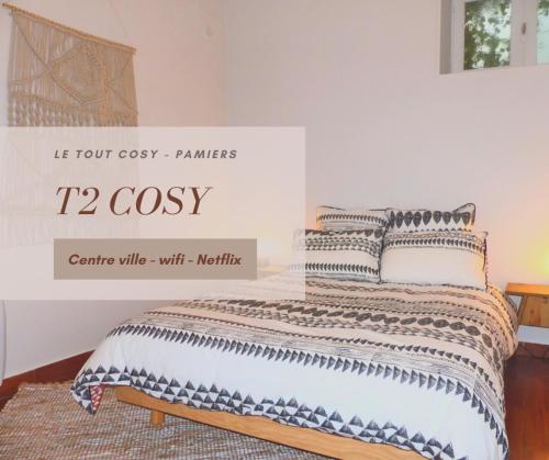 a bedroom with a bed with a case at Le tout cosy - Wifi - Disney - EvasionPamiers in Pamiers