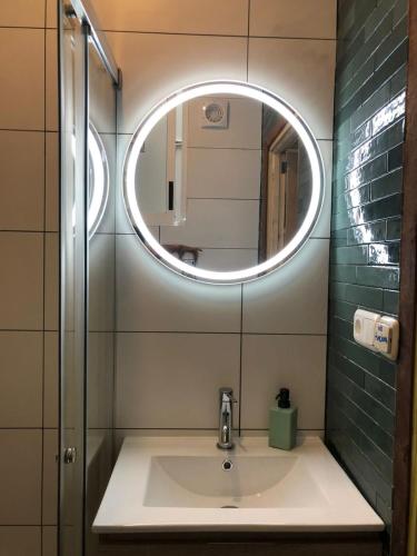 a bathroom with a sink and a mirror at Beach House San Sebastian in San Sebastián