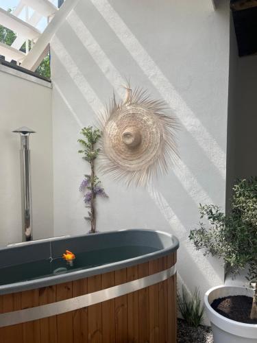 a bathroom with a bath tub with a plant on the wall at Het sfeerhuis aan zee in Vlissingen