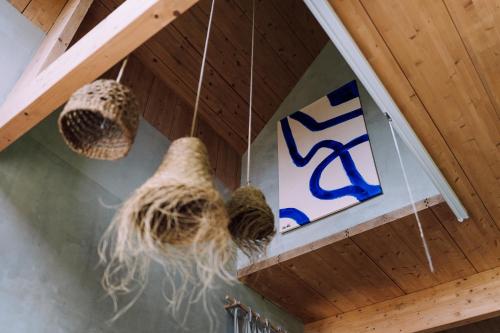 two nests are hanging from a ceiling with a sign at Stodoła naturalnie - dom z balią na Kaszubach in Brodnica