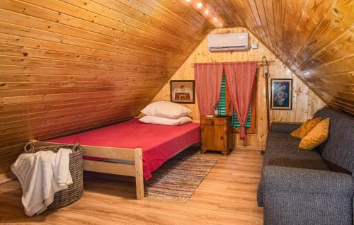 a bedroom with a bed in a wooden cabin at Kuca za odmor klet Šaban in Šiljakovina