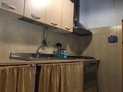 a kitchen with a sink and a stove at Tenuta Nonno Carmine in Porto Cesareo