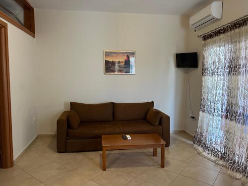 a living room with a couch and a coffee table at Villa Alexandra in Agia Marina Aegina