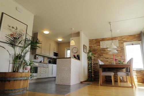 a kitchen with a table and a dining room at Nordic lights villa in Sigtuna