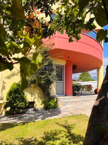 a house with a red and yellow at Vacation House in Agiokampos in AgiaKampos