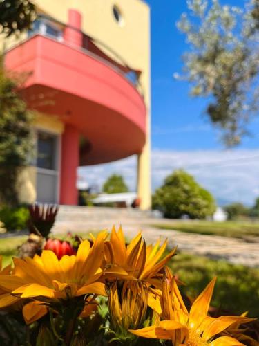 a bouquet of yellow flowers in front of a house at Vacation House in Agiokampos in AgiaKampos