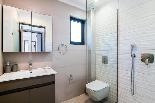 a bathroom with a toilet and a sink and a shower at Lea Villa - Brand New Modern Villa! in Zakynthos Town