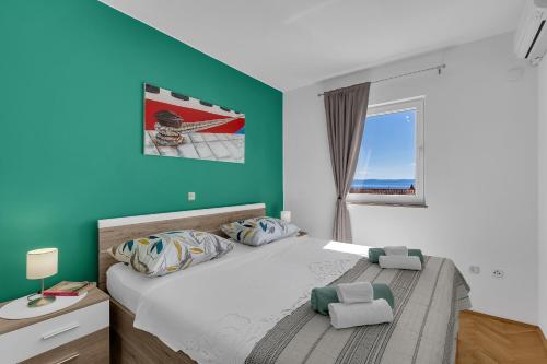 a bedroom with a bed and a window at Newly renovated apartment with a beautiful sea view Emili in Promajna