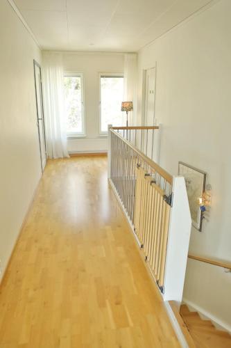 an empty hallway with a staircase in a home at Nordic lights villa in Sigtuna
