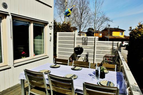 a table and chairs on a patio with a fence at Nordic lights villa in Sigtuna