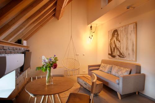 a living room with a couch and a table at B&B Le Rêve Maastricht in Maastricht