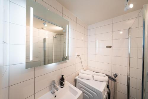 a bathroom with a toilet and a sink and a mirror at TA Seminarbakken City Studio in Tromsø