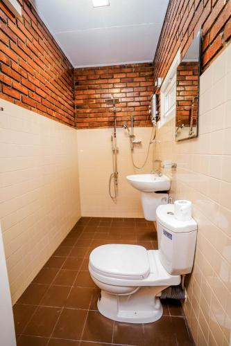 a bathroom with a toilet and a sink at River Inn in Matara
