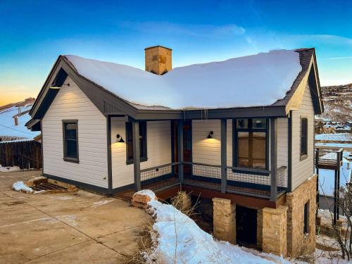 a small white house with snow on the roof at 502 A Gold Coast! townhouse in Park City