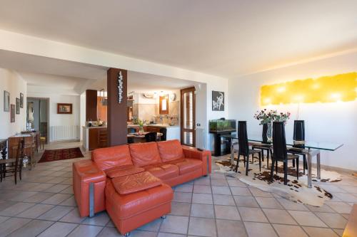 a living room with a couch and a dining room at Water Front Scopello in Scopello