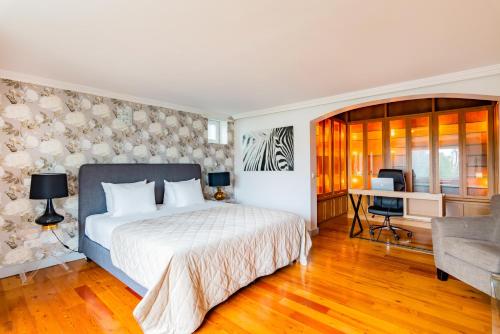 a bedroom with a bed and a desk at Estoril Riviera Apartments in Estoril