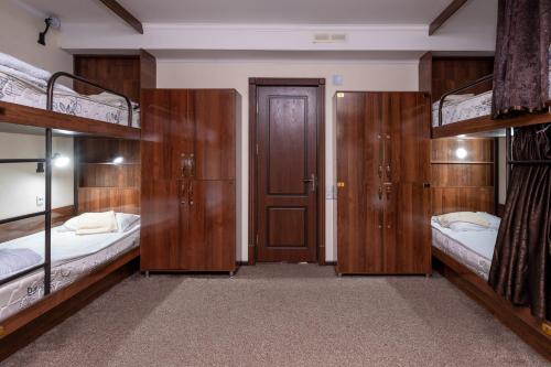 a room with two bunk beds and a door at Hostel makon in Kirgili